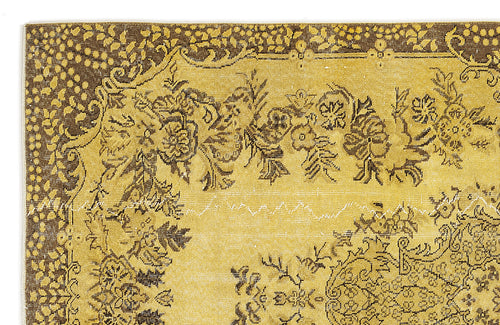 Load image 1 in gallery view. Mustard yellow and dark brown rug with a distressed floral medallion pattern and a decorative border.