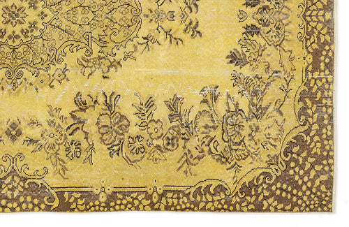 Load image 1 in gallery view. Mustard yellow and brown distressed rug with a traditional floral medallion pattern and ornate border.