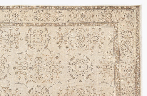 Load image 1 in gallery view. Beige and taupe traditional rug with a distressed floral medallion pattern and a detailed geometric border.