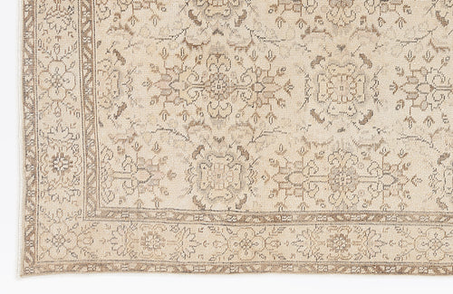 Load image 1 in gallery view. Beige and taupe traditional rug with a distressed floral medallion pattern and a detailed border.
