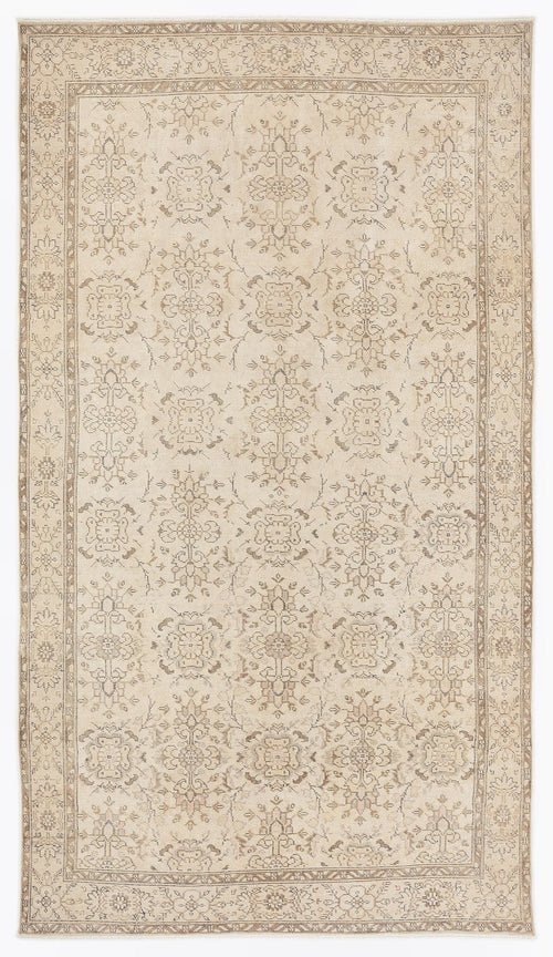 Load image 1 in gallery view. Beige and taupe traditional rug with a repeating floral medallion pattern and a detailed border.