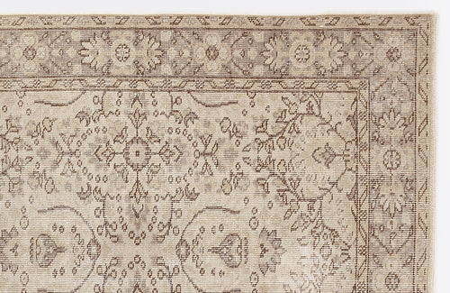 Load image 1 in gallery view. Beige and brown rug with a distressed traditional floral medallion pattern and a geometric border.