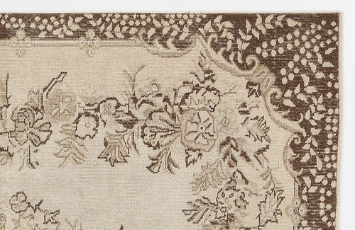 Load image 1 in gallery view. Beige and dark brown rug with a traditional floral medallion border and intricate botanical motifs.