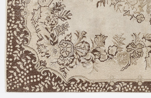 Load image 1 in gallery view. Beige and brown rug with a traditional floral medallion pattern and a dense, dotted border.