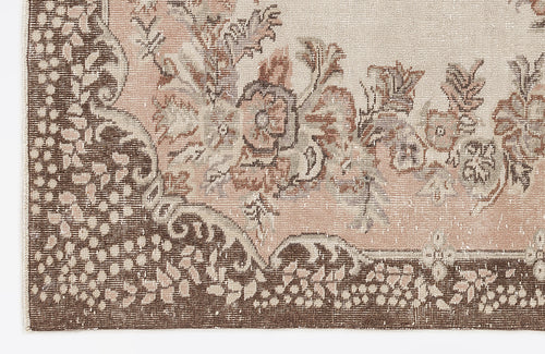 Load image 1 in gallery view. Distressed beige and brown rug with a floral medallion pattern and a detailed dotted border.