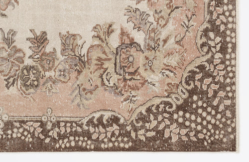 Load image 1 in gallery view. Distressed beige and brown rug with a floral medallion pattern and a detailed botanical border.
