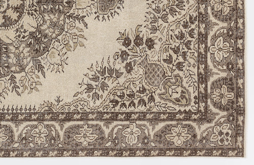 Load image 1 in gallery view. Beige and dark brown rug with a traditional floral medallion pattern and a detailed decorative border.