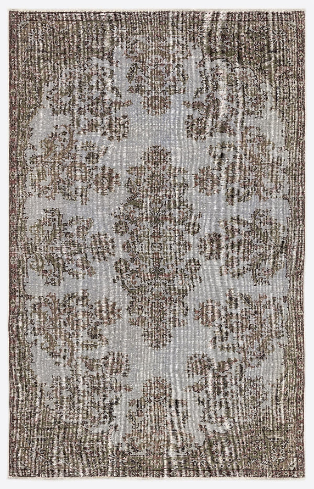 Light blue and brown distressed rug with a traditional floral medallion pattern and a decorative border.