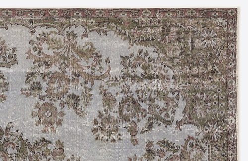 Load image 1 in gallery view. Distressed vintage-style rug with sage green, grey, and rust floral medallion patterns on a light grey background.