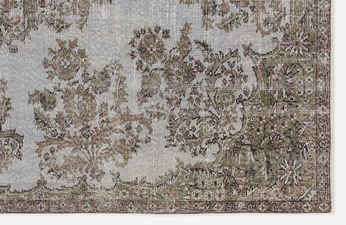 Load image 1 in gallery view. Distressed light blue rug with a faded floral medallion pattern in olive green and brown tones.