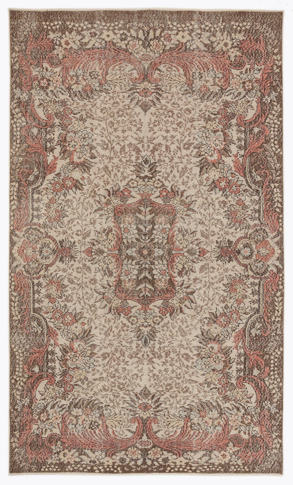 Brown and cream traditional rug with a distressed floral medallion pattern and coral-toned accents.