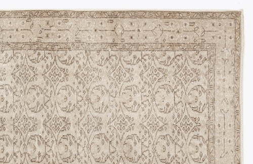 Load image 1 in gallery view. Beige and taupe traditional rug with a distressed floral medallion pattern and a decorative border.