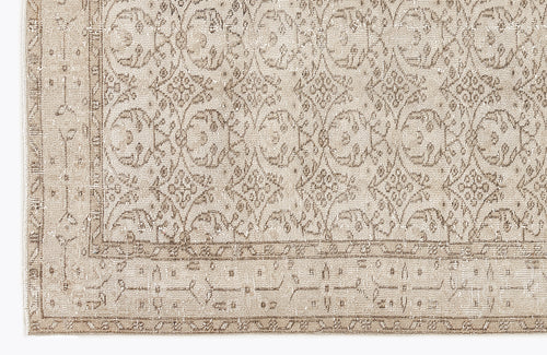 Load image 1 in gallery view. Beige and taupe distressed rug with a traditional floral medallion pattern and a geometric border.
