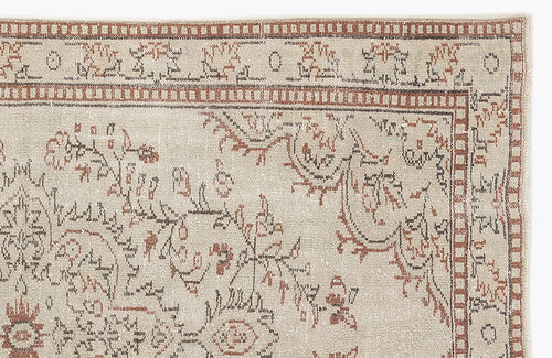 Load image 1 in gallery view. Beige rug with a distressed terracotta and charcoal floral medallion pattern and a geometric border.