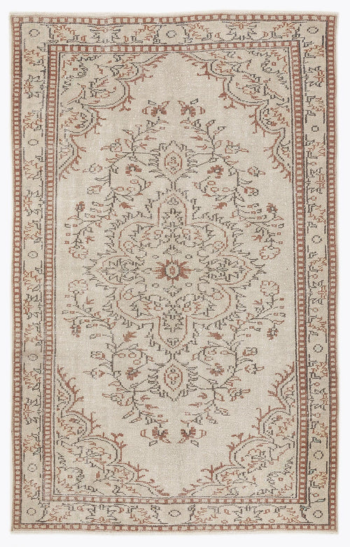 Load image 1 in gallery view. Beige vintage-style rug with a distressed terracotta and charcoal floral medallion pattern and a geometric border.