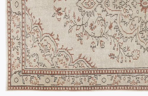 Load image 1 in gallery view. Beige rug with a distressed brown floral medallion pattern and a geometric border.