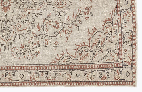 Load image 1 in gallery view. Beige rug with a distressed rust and charcoal floral medallion pattern and a geometric border.