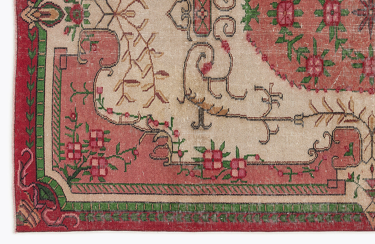 Beige, red, and green traditional rug with a floral medallion pattern and geometric border.