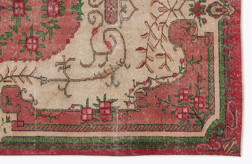 Load image 1 in gallery view. Beige, red, and green traditional rug with a floral medallion pattern and a geometric border.