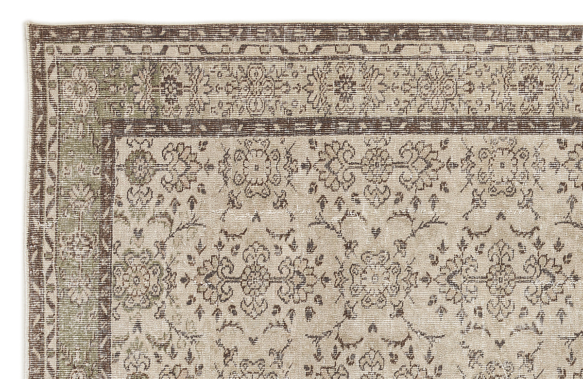 Beige and brown traditional rug with a distressed floral medallion pattern and a decorative border.