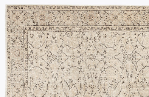 Load image 1 in gallery view. Beige and taupe rug with a distressed traditional floral medallion pattern and a decorative border.