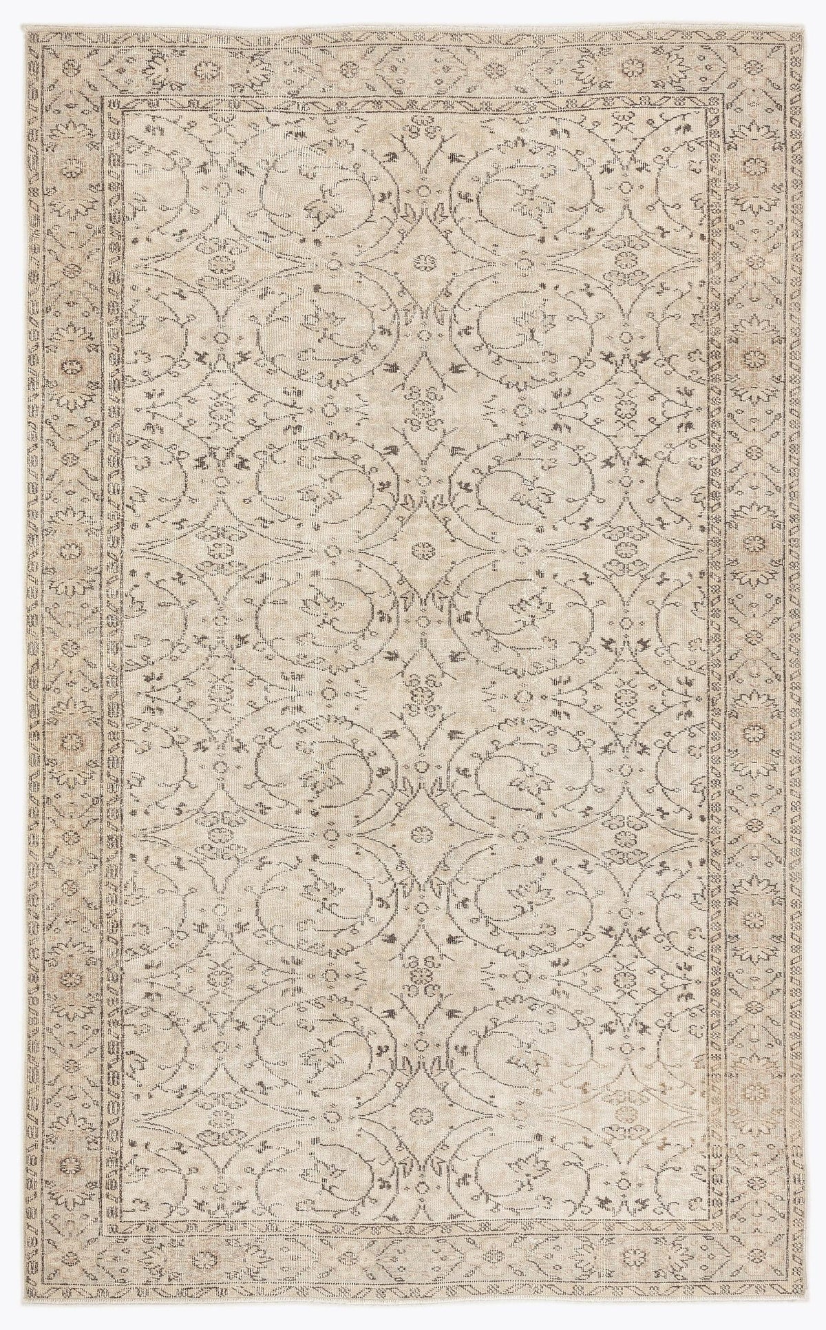 Beige and charcoal grey area rug with a repeating floral medallion pattern and a decorative border.