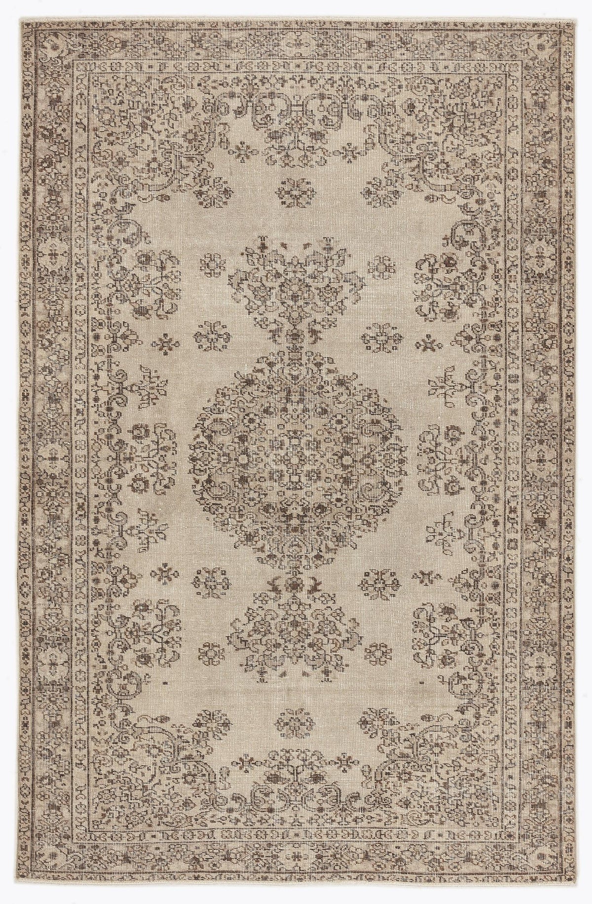 Beige and brown traditional rug with a distressed central medallion and ornate floral border.