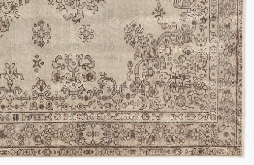 Load image 1 in gallery view. Beige and brown rug with a distressed traditional floral medallion pattern and a detailed geometric border.