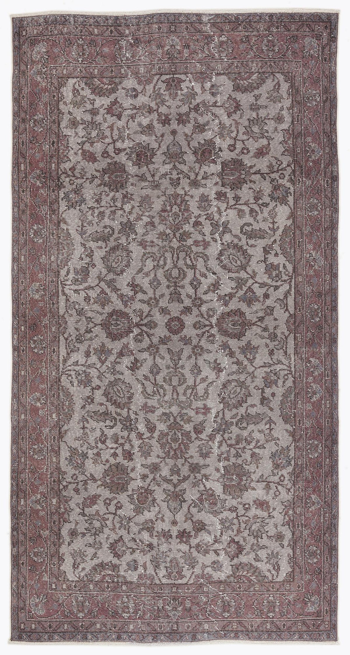 Distressed grey and burgundy rug with a traditional floral medallion pattern and a wide decorative border.