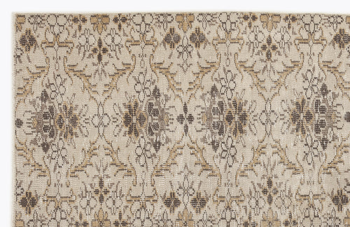 Load image 1 in gallery view. Beige rug with a repeating dark brown and tan floral medallion pattern on a textured, neutral background.