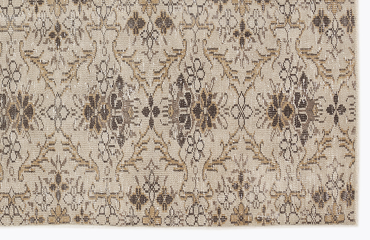 Beige and brown rug with a repeating distressed floral medallion pattern.