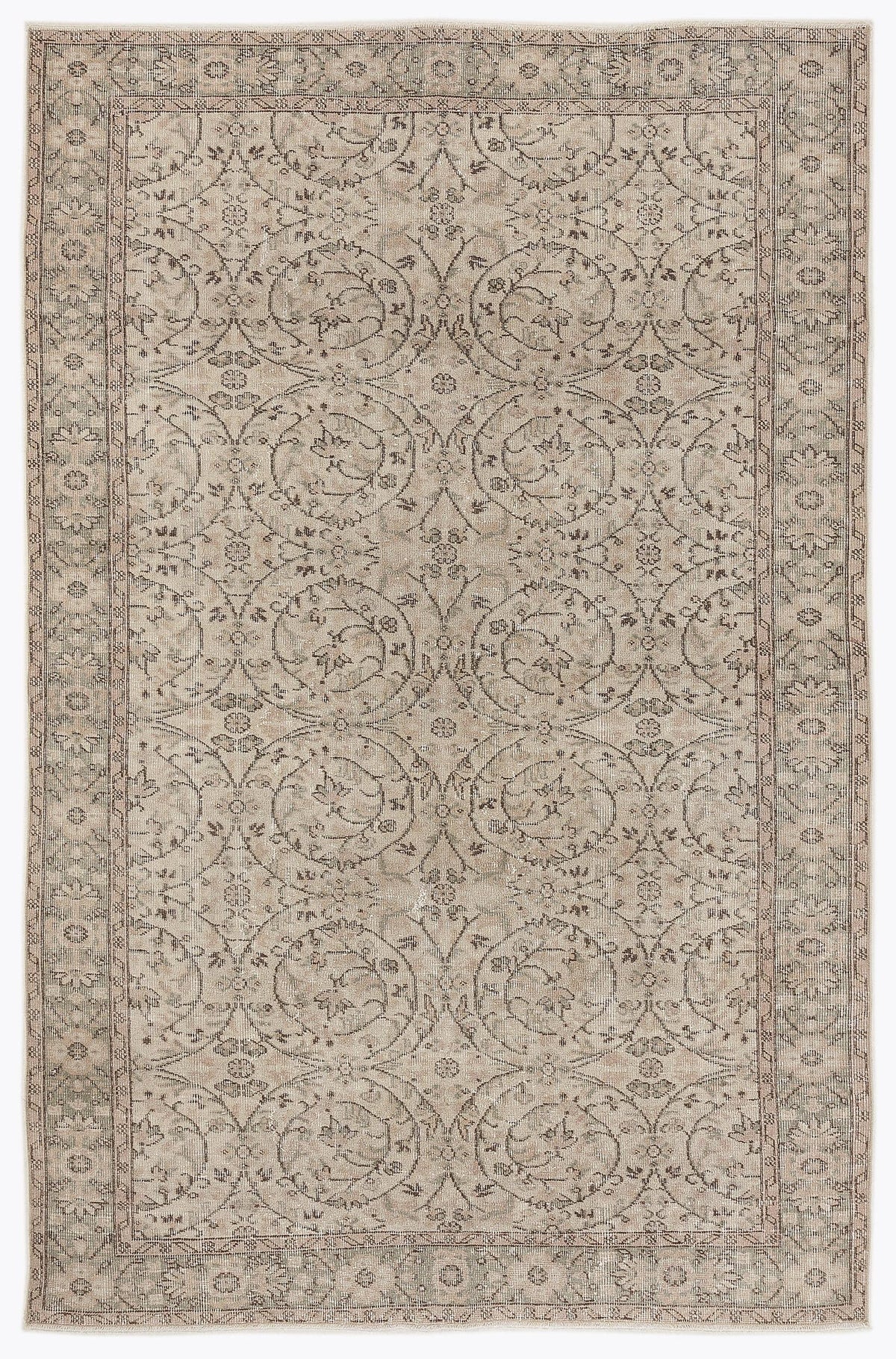 Beige and grey traditional rug with a repeating floral medallion pattern and a decorative border.