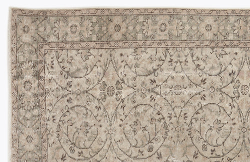 Load image 1 in gallery view. Beige and taupe vintage-style rug with a distressed floral medallion pattern and a detailed border.