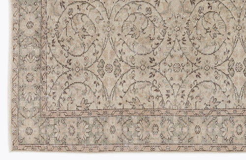 Load image 1 in gallery view. Beige and taupe traditional rug with a distressed floral medallion pattern and a detailed border.