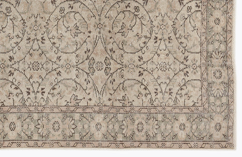Load image 1 in gallery view. Beige and taupe traditional rug with a distressed floral medallion pattern and a detailed border.