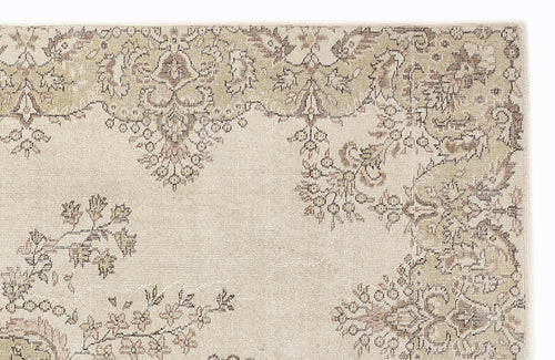Load image 1 in gallery view. Beige and taupe rug with a distressed traditional floral medallion pattern on a white background.