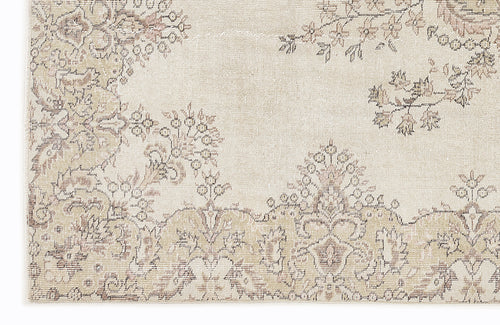 Load image 1 in gallery view. Cream and beige rug with a faded, distressed floral medallion pattern.