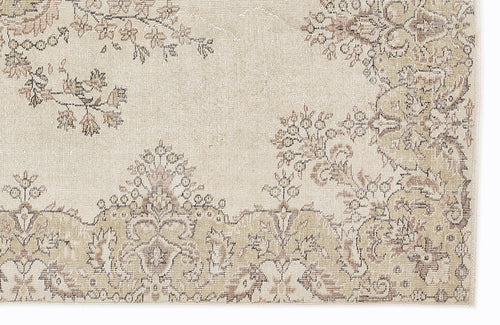 Load image 1 in gallery view. Beige and taupe traditional rug with a distressed floral medallion pattern on a white background.