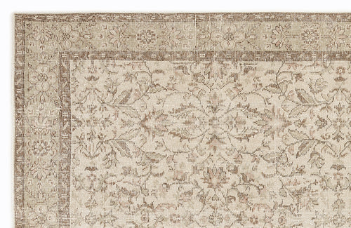 Load image 1 in gallery view. Beige and brown traditional rug with a distressed floral medallion pattern and a geometric border.