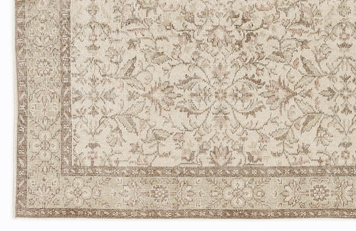 Load image 1 in gallery view. Beige and taupe rug with a traditional floral medallion pattern and a detailed border.