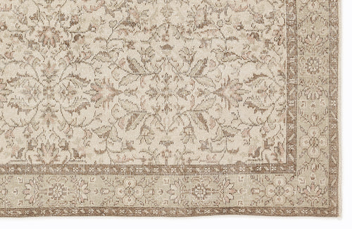 Load image 1 in gallery view. Beige and taupe traditional rug with a distressed floral medallion pattern and a detailed border.