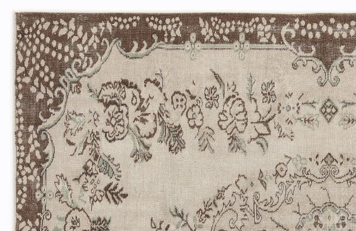 Load image 1 in gallery view. Brown and beige rug with a distressed floral medallion pattern and intricate border details on a white background.