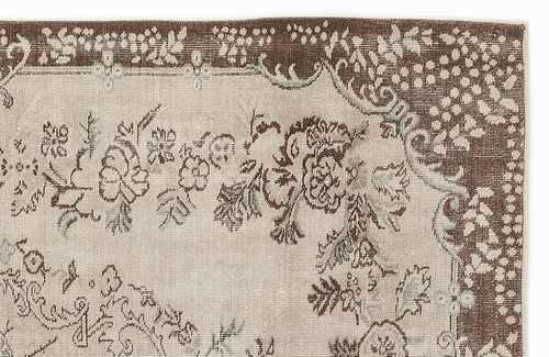 Load image 1 in gallery view. Beige and brown vintage-style rug with a distressed floral medallion pattern and a wide decorative border.