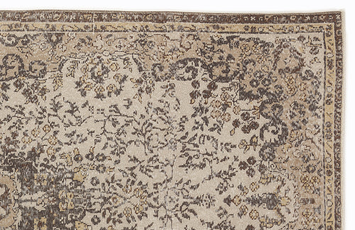 Load image 1 in gallery view. Beige and dark brown rug with a distressed traditional floral pattern and a decorative border.