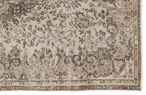 Load image 1 in gallery view. Beige and dark brown rug with a distressed, traditional floral pattern and a bordered edge.
