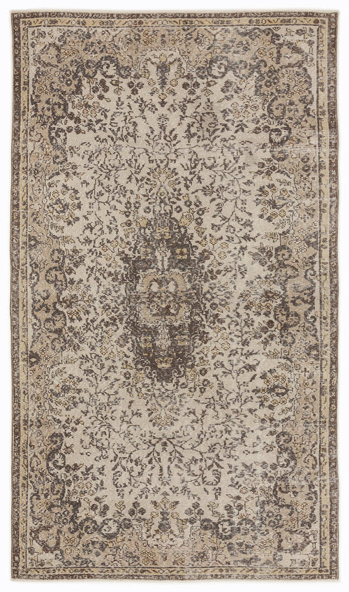 Load image 1 in gallery view. Beige and dark brown traditional rug with a distressed floral medallion pattern and a decorative border.