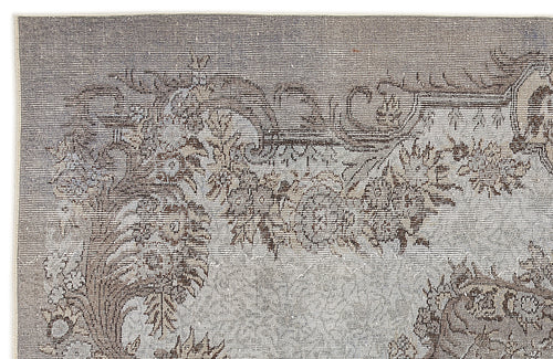 Load image 1 in gallery view. Grey and brown vintage-style rug with a distressed floral medallion pattern on a white background.