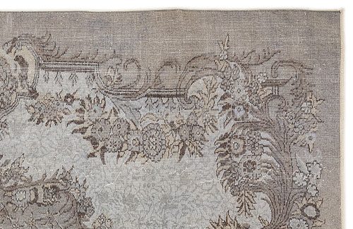 Load image 1 in gallery view. Grey and brown distressed rug with a traditional floral medallion pattern on a white background.