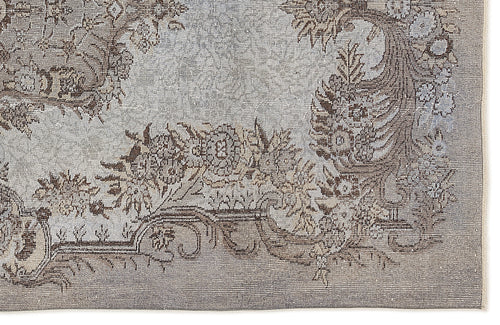 Load image 1 in gallery view. Grey and brown traditional rug with a distressed floral medallion pattern on a white background.