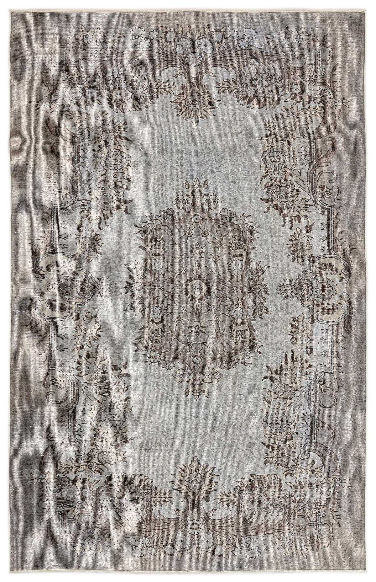 Grey and taupe traditional rug with a distressed floral medallion pattern on a white background.